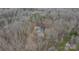 Aerial view of a secluded home nestled among dense trees and offering a unique private setting at 369 Falcon Dr, Concord, NC 28025