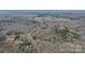 Aerial view shows houses and plots nestled in a forest with sparse winter foliage at 369 Falcon Dr, Concord, NC 28025