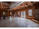 Unfinished basement with exposed insulation, beams and access to the backyard at 369 Falcon Dr, Concord, NC 28025