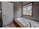 Bathroom showing tub with tile accents and natural light from window at 369 Falcon Dr, Concord, NC 28025