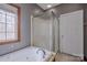 Bathroom with a shower, tub, and window at 369 Falcon Dr, Concord, NC 28025