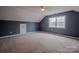 Spacious carpeted bedroom features a window with natural light and a ceiling fan at 369 Falcon Dr, Concord, NC 28025