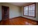 Bedroom featuring wood floors, natural light, and wooden trim at 369 Falcon Dr, Concord, NC 28025