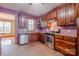 Charming kitchen with wooden cabinetry, stainless steel appliances and tile flooring at 369 Falcon Dr, Concord, NC 28025