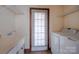 Bright laundry room with utility sink, shelving, and washer and dryer at 369 Falcon Dr, Concord, NC 28025