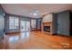 Bright living room featuring a cozy stone fireplace, hardwood floors, and lots of natural light at 369 Falcon Dr, Concord, NC 28025