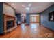 Open living room with wood burning fireplace, ceiling fan and hardwood floors throughout at 369 Falcon Dr, Concord, NC 28025