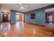 Spacious living room featuring hardwood floors, a ceiling fan, and natural light at 369 Falcon Dr, Concord, NC 28025