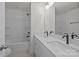 Bathroom with double vanity, large mirror, and shower-tub combo at 4109 Walking Ridge Rd # 57, Charlotte, NC 28208