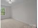 Well-lit bedroom featuring a window and neutral carpeting at 4109 Walking Ridge Rd # 57, Charlotte, NC 28208