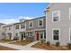 Three modern townhomes with stone accents, modern windows, and beautiful landscaped yards at 4109 Walking Ridge Rd # 57, Charlotte, NC 28208