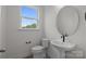 Half bathroom with modern fixtures and pedestal sink at 4109 Walking Ridge Rd # 57, Charlotte, NC 28208