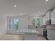 Bright kitchen features modern white cabinets, stainless steel appliances, and beautiful wooden floors at 4109 Walking Ridge Rd # 57, Charlotte, NC 28208