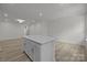 Bright kitchen featuring island with white cabinets, stainless steel appliances, and wooden floors at 4109 Walking Ridge Rd # 57, Charlotte, NC 28208