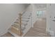 Wooden staircase leading to the upper level of the home at 4109 Walking Ridge Rd # 57, Charlotte, NC 28208