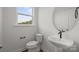 Bathroom with pedestal sink and toilet under a large window at 4113 Walking Ridge Rd # 56, Charlotte, NC 28208