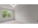 This bedroom features a neutral color palette and a large window at 4113 Walking Ridge Rd # 56, Charlotte, NC 28208