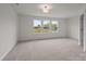 This bedroom features a neutral color palette and large windows at 4113 Walking Ridge Rd # 56, Charlotte, NC 28208