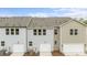 Exterior of newly built townhomes featuring garages, lights, and well-maintained yards at 4113 Walking Ridge Rd # 56, Charlotte, NC 28208