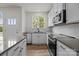 Well-lit kitchen featuring stainless steel appliances and white cabinetry at 4113 Walking Ridge Rd # 56, Charlotte, NC 28208