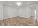 Spacious living room featuring neutral paint, lighting, and vinyl plank flooring at 4113 Walking Ridge Rd # 56, Charlotte, NC 28208