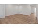 A standard bedroom with wood-look floors, neutral paint, and ample lighting at 4117 Walking Ridge Rd # 55, Charlotte, NC 28208
