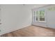 Well-lit bedroom features wood-look floors, white walls, and a double window at 4117 Walking Ridge Rd # 55, Charlotte, NC 28208