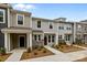 Charming townhome boasts gray siding, stone accents, and a welcoming front entrance at 4117 Walking Ridge Rd # 55, Charlotte, NC 28208