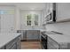 Bright kitchen features white cabinets, quartz countertops, and stainless steel appliances at 4117 Walking Ridge Rd # 55, Charlotte, NC 28208