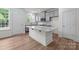 Modern kitchen with a large center island, gray cabinets and stainless steel appliances at 4117 Walking Ridge Rd # 55, Charlotte, NC 28208