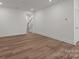Large living area with wood-look floors, neutral paint, and staircase access at 4117 Walking Ridge Rd # 55, Charlotte, NC 28208