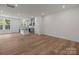 Open concept living area with wood-look floors, neutral walls, and updated kitchen at 4117 Walking Ridge Rd # 55, Charlotte, NC 28208