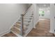 Wood and white staircase with white walls and wood-look floors at 4117 Walking Ridge Rd # 55, Charlotte, NC 28208