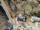 The aerial view of this property shows the home, detached garage and wooded backyard at 457 Birchwood Ne Trl, Concord, NC 28025