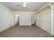 Bedroom with wall to wall carpet, ceiling fan, and multiple doorways at 457 Birchwood Ne Trl, Concord, NC 28025