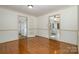 Bright dining room features hardwood floors and multiple doorways to other rooms at 457 Birchwood Ne Trl, Concord, NC 28025
