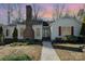Charming single-story home features a brick chimney, red shutters, and a well-maintained front yard at 457 Birchwood Ne Trl, Concord, NC 28025