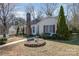 Traditional-style home with red shutters and a brick chimney, surrounded by a well-manicured lawn at 457 Birchwood Ne Trl, Concord, NC 28025