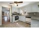 Functional kitchen with tiled floors, white appliances, and a window, connecting seamlessly to the living space at 457 Birchwood Ne Trl, Concord, NC 28025