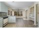 Bright kitchen featuring ample natural light, tiled floors, and a built-in desk area, enhancing functionality at 457 Birchwood Ne Trl, Concord, NC 28025