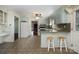 Charming kitchen with breakfast bar, tiled floors, and white appliances, offers a view into the living area at 457 Birchwood Ne Trl, Concord, NC 28025