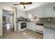 Functional kitchen with tiled floors, white appliances, and a window, connecting seamlessly to the living space at 457 Birchwood Ne Trl, Concord, NC 28025