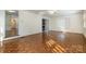 Bright living room with gleaming wood floors and large windows, perfect for relaxing and entertaining at 457 Birchwood Ne Trl, Concord, NC 28025