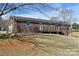 Exterior of the home's backyard featuring a wooden deck with pergola and brick at 4866 E Nc Hwy 150 Hwy, Lincolnton, NC 28092