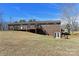 Spacious backyard featuring a wooden deck with pergola, walk-out basement, and brick exterior at 4866 E Nc Hwy 150 Hwy, Lincolnton, NC 28092