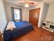 Cozy bedroom with wood-look floors, a double bed, and a window for natural light at 4866 E Nc Hwy 150 Hwy, Lincolnton, NC 28092