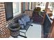A charming front porch featuring a swing with blue pillows and black flowerpot at 4866 E Nc Hwy 150 Hwy, Lincolnton, NC 28092
