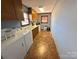 Functional laundry room with washer, dryer, sink, storage cabinets, and laminate flooring at 4866 E Nc Hwy 150 Hwy, Lincolnton, NC 28092