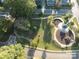 Aerial view of a neighborhood park with green spaces, walkways, playground, and a central gazebo at 616 Smith St # A, Mooresville, NC 28115