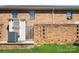 Enclosed brick backyard with private entrance and exterior A/C unit at 6322 Old Pineville Rd # E, Charlotte, NC 28217